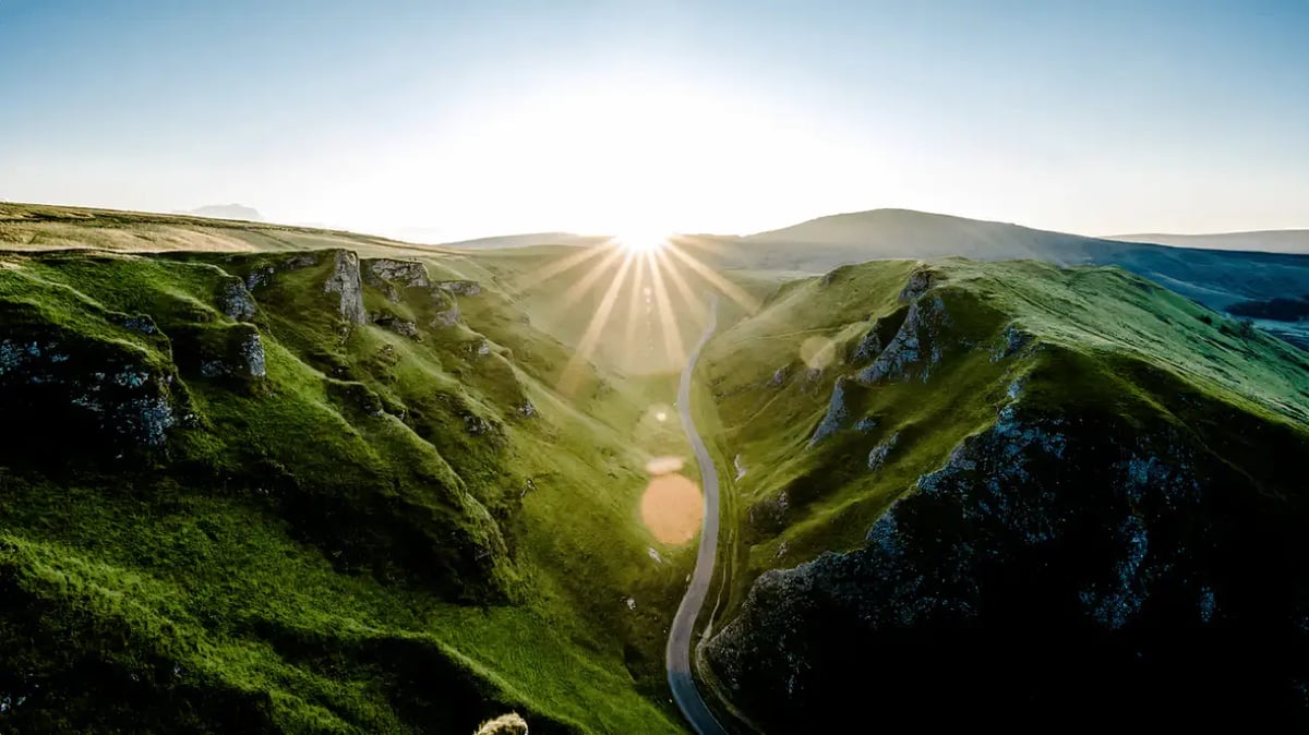 Sunrise over green mountain landscape